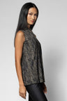 A woman modeling a sleeveless, textured black and gray top against a light gray studio background.